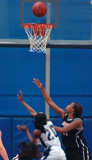 Rochester's Tiona Bacon trying to shoot over Aliquippa's Jocyln
Walkins during the game.