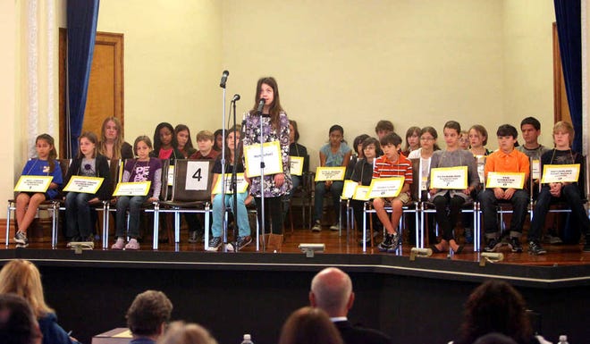 Seventh-grade homeschooler Grace Remmer spells her first word during the St. Johns County Spelling Bee in the school district's auditorium on Wednesday morning, January 18, 2012. BY DARON DEAN, daron.dean@staugustine.com