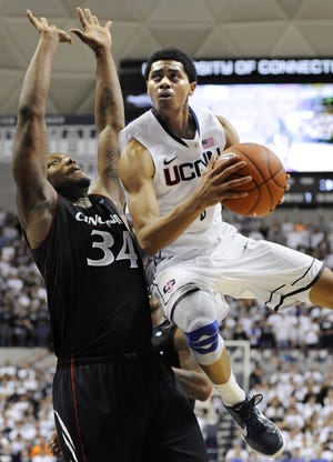 UConn's Jeremy Lamb, right, drives to the basket Wednesday while being guarded by Cincinnati's Yancy Gates in the second half of the Huskies' 70-67 loss in Storrs.