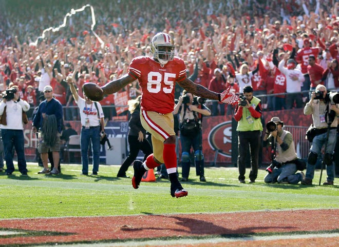 FILE - In this Jan. 14, 2012, file photo, San Francisco 49ers tight end Vernon Davis (85) celebrates after scoring on a 49-yard touchdown reception during the first quarter of an NFL divisional playoff football game against the New Orleans Saints in San Francisco. With a record-setting day and the winning touchdown in his playoff debut, Davis left no doubt he is indeed a winner. The 49ers' tight end has come a long way. Three years earlier, he became the focus of then-coach Mike Singletary's now infamous "I want winners" rant following a loss (AP Photo/Paul Sakuma, File)