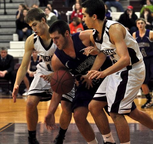 Whaley/Democrat photo
Marshwood's Jack Verrill, center, loses control of the ball as he is guarded by Noble's Adam Della-Piana, left, and Kyle Sillion during Western Maine Class A action Friday in North Berwick. Marshwood won, 59-46.