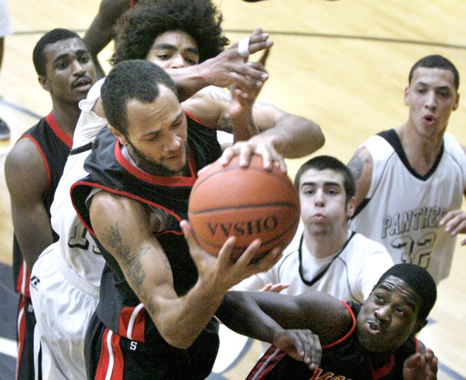 McKinley’s Mike Mills gets a rebound in front of Perry’s Khyler Fields during the first quarter of Friday’s game at Perry.