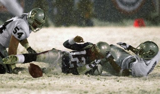 On the snowy night of Jan. 19, 2002, a football dynasty was born. With less than two minutes to play and the Patriots down 13-10, quarterback Tom Brady lost the ball after being sacked by Charles Woodson, right, then with the Oakland Raiders. The play was initially ruled a fumble but officials overturned the call after determining that Brady's arm was moving forward, thus making it an incomplete pass. That gave the Patriots the ball and new life in the AFC championship game, essentially ushering in an era of Patriots dominance in the NFL.