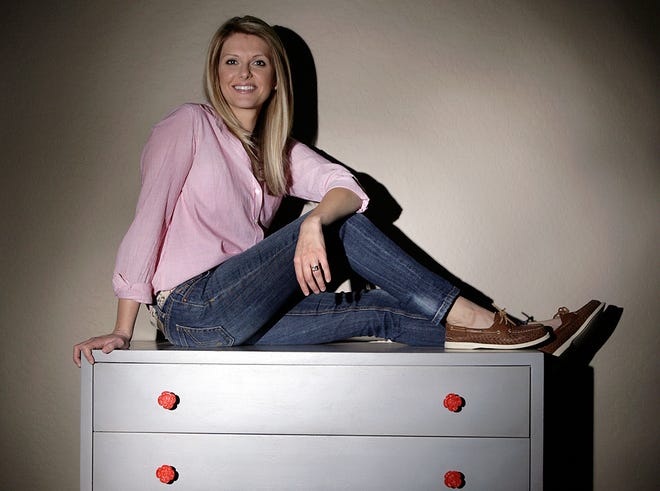 Natalie Cox, owner of “Natty by Design” and a mother of four, displays a dresser she refurbished for a customer Nov. 11 in the garage of her home in Gilbert, Ariz.