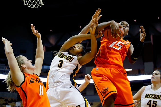 Oklahoma State’s Toni Young (15) rips the ball from Missouri’s Bree Fowler during the Cowgirls’ 62-58 victory at Mizzou Arena.