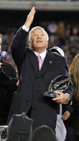 New England Patriots owner Robert Kraft touches his hand to his heart and gestures upward as he thanks the fans for their support during "this difficult year" and accepts the Lamar Hunt Trophy after the Patriots beat the Baltimore Ravens in the AFC Championship game at Gillette Stadium in Foxboro on Sunday, Jan. 22, 2012. (Emily J. Reynolds/The Enterprise)