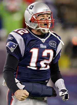 Patriots quarterback Tom Brady celebrates after scoring what proved to be the winning touchdown during New England's 23-20 win over the Ravens in the AFC Championship.