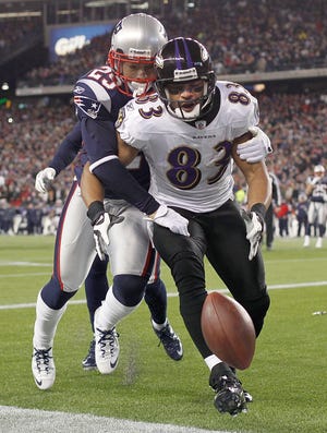 Ravens wide receiver Lee Evans (83) is stripped of the ball by Patriots defensive back Sterling Moore in the end zone during the final minute of New England's 23-20 victory over Baltimore.
