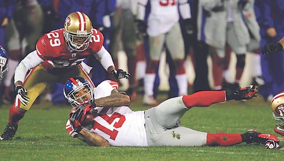 San Francisco 49ers' Chris Culliver (29) watches as New York Giants' Devin Thomas (15) recovers a fumbled punt by Kyle Williams during overtime of the NFC Championship NFL football game Sunday, Jan. 22, 2012, in San Francisco. (AP Photo/Julie Jacobson)