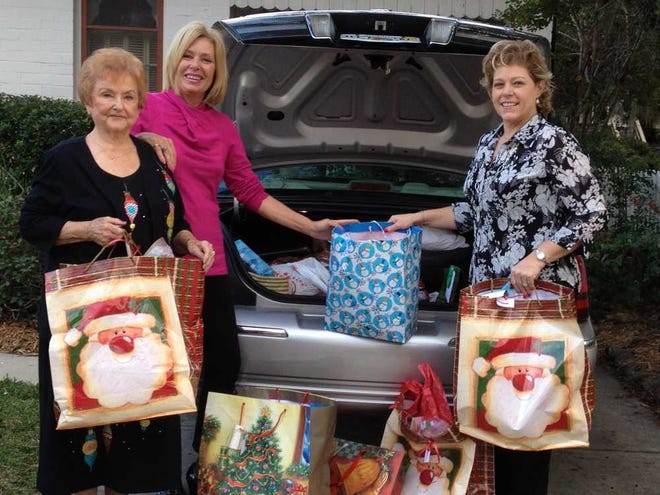 Nettie Ruth Brown, from left; Katherine Jose and Renee Marcy with donations for St. Augustine Youth Services. Contributed photo.