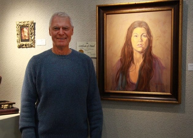 Richard Hausen with his oil portrait "Morning Flower."