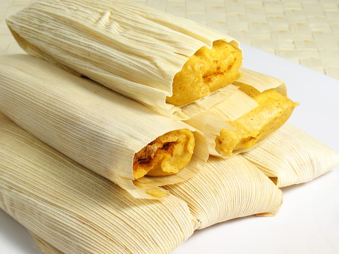 Replacing the lard found in most tamale recipes with a homemade chicken broth cooked with garlic, onions and chilies can make this classic Mexican dish a healthier meal.