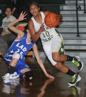 Pius X's Daniela Gonzalez, left, gets tripped up as Notre Dame of East Stroudsburg's Rebecca Bailey (10) gets the ball during their game on Monday night, January 23, 2012.