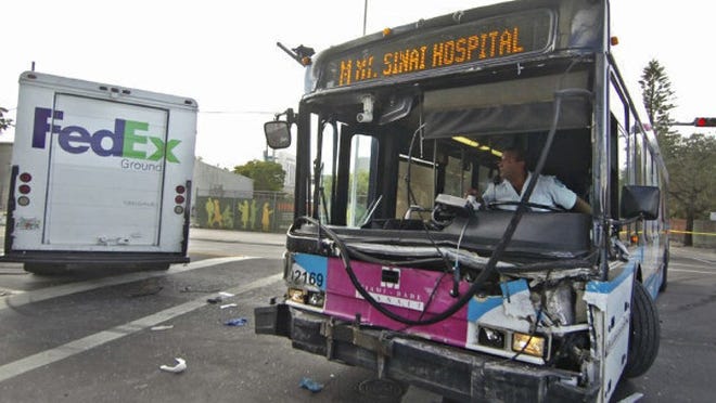 A Miami-Dade transit bus heading to Mount Sinai Medical Center was hit by a FedEx truck Tuesday in Miami, sending at least 18 people to area hospitals.