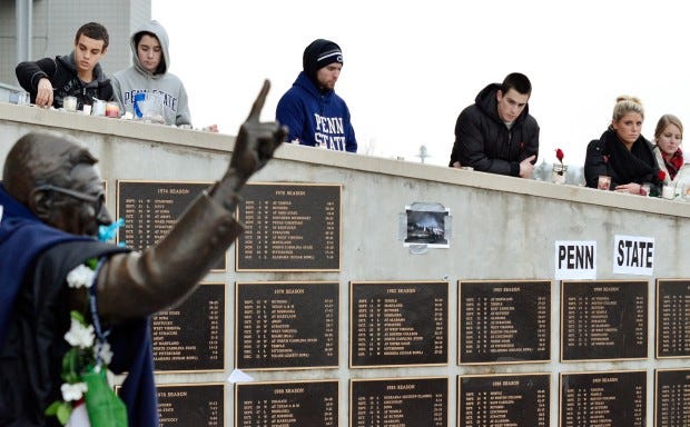 Students gather at the Joe Paterno statue outside Beaver Stadium
after the funeral procession for Penn State football coach Joe
Paterno at Penn State University in State College on Wednesday.