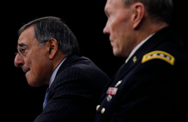 Sec. of Defense Leon Panetta, left, and Chairman of the Joint Chiefs of Staff Gen. Martin E. Dempsey, right, outline the main areas of proposed spending cuts during a news conference at the Pentagon in Washington, Thursday, Jan., 26, 2012. (AP Photo/Pablo Martinez Monsivais)