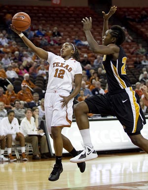 Texas’ Yvonne Anderson (12) scores in front of Missouri’s Bre- Anna Brock during the second half of the Longhorns’ 75-58 victory Wednesday night. Anderson scored 18 points.