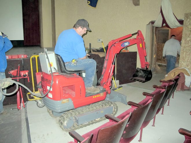 Kurk Eldridge, foreman for William Morris and Son Inc., unearths old piping at the Ionia Theatre Tuesday. The pipes were corroded and blocked, and needed to be replaced.