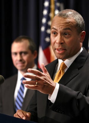 Massachusetts Gov. Deval Patrick, answers questions from reporters as Secretary of Administration and Finance Jay Gonzalez looks on during a press conference yesterday at the State House, in Boston.