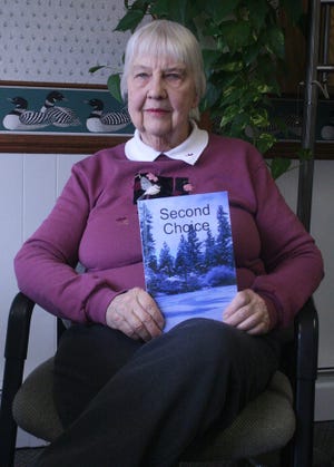 Shirley Bergstrom shows off her book “Second Choice,” developed from stories shared about the ‘Swede town’ settlement east of Cheboygan in the last 1880s.