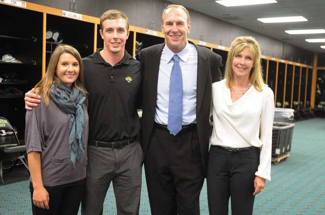 Kelly.Jordan@jacksonville.com--011112--The Jaguars new head coach, second from right, poses for photographs with his family from left Kristin Karfgin, fiancee of Patrick Mularkey, second from left and his wife Betsy Mularkey, in the Jaguars locker room at EverBank Field Wednesday, January 11, 2012 in Jacksonville, Florida.(The Florida Times-Union, Kelly Jordan)