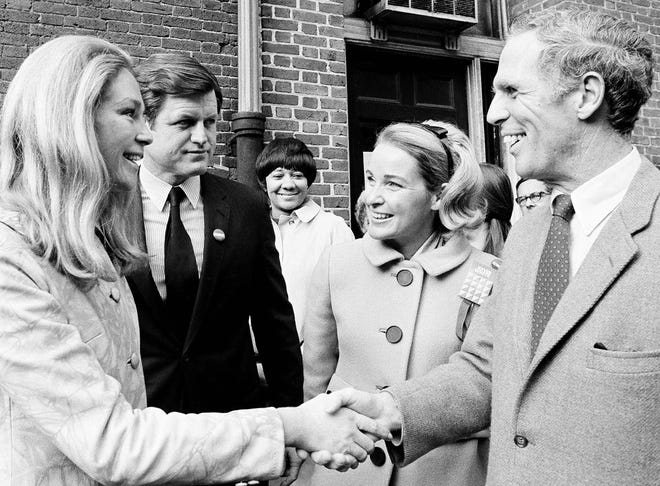 In this Tuesday, Nov. 3, 1970, Sen. Edward Kennedy, center, and his wife, Joan, left, greet Boston Mayor Kevin White and his wife, Kathryn White, at their Charles street polling place in Boston Mass. Former Boston Mayor Kevin White died Friday, Jan. 27, 2012. White was diagnosed with Alzheimer's disease in 2003. A family spokesman says he died at home surrounded by family. He was 82.