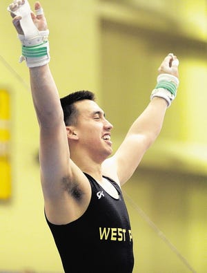 Army's Andrew Avelino raises his arms after competing on the high bar at the 2012 West Poin Gymnastic Open at Christl Arena on Friday, Jan. 27, 2012.