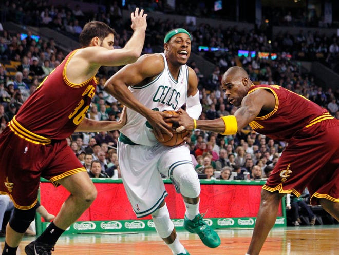 Boston Celtics' Paul Pierce, center, drives between Cleveland Cavaliers' Omri Casspi, left, and Antawn Jamison during the first quarter of an NBA basketball game in Boston, Sunday, Jan. 29, 2012. (AP Photo/Michael Dwyer)
