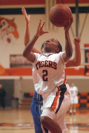 Massillon’s Alana Stokes drives to the basket for a layup during Saturday’s 61-58 loss to Wooster at Washington High School. The Tigers, 10-5 overall, have now lost three straight games.