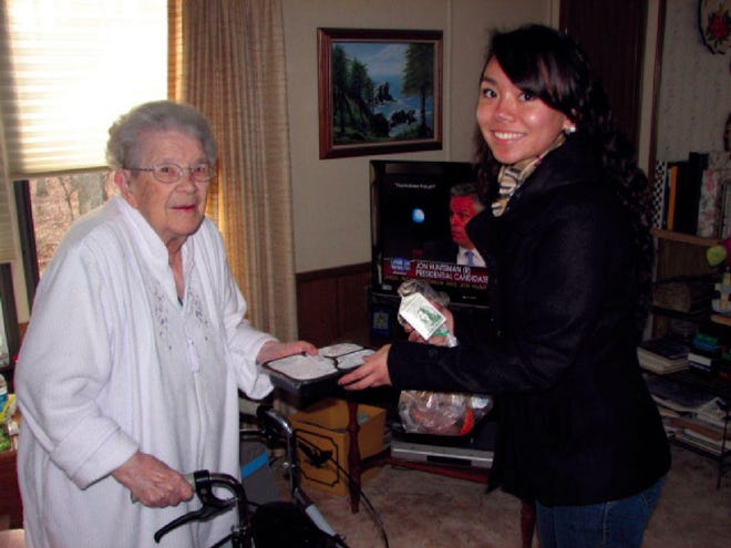 Stroudsburg High School senior Alysha Moises delivers a meal packet to Edith Flory in her East Stroudsburg home.