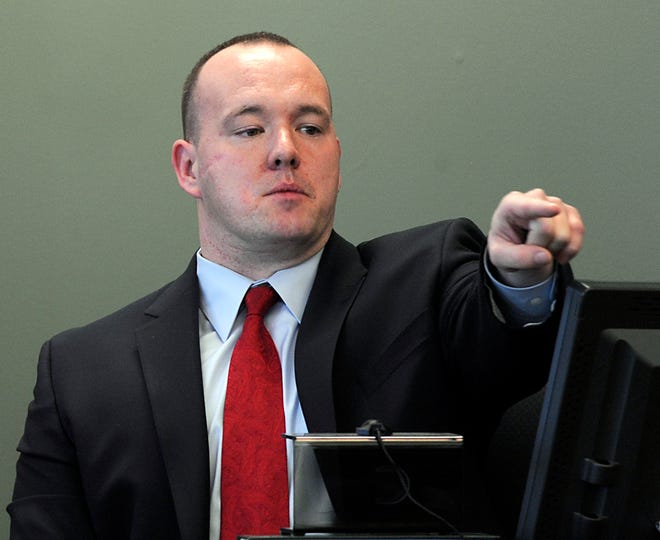 Framingham Police Sgt. Philip Hurton points to Sahr Josiah in Middlesex Superior Court Tuesday, identifying him as the man who shot him in 2009.