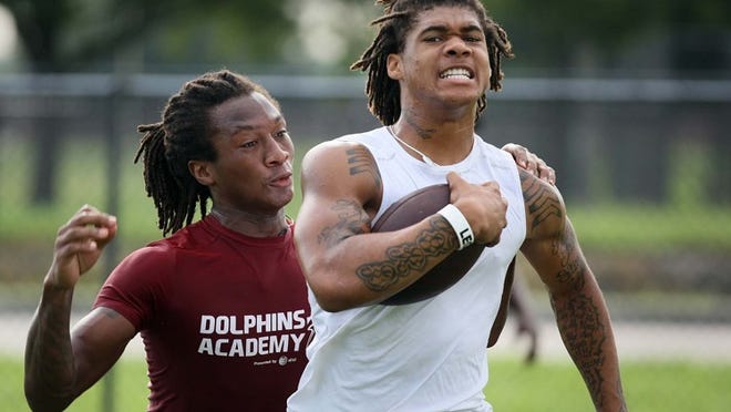 David Bailey attempts to knock the ball out of the hands of Crevon LeBlanc during a practice drill at Glades Central. LeBlanc has a verbal commitment to play at FAU this fall.