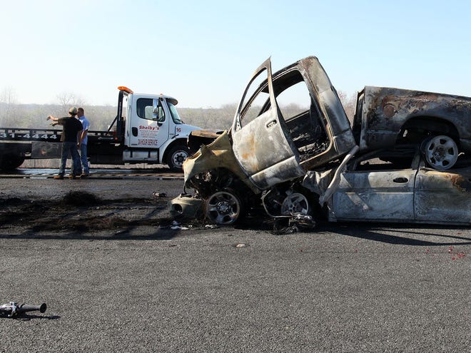 Officials work the scene of a multi-vehicle crash with multiple fatalities on Interstate 75 near the southern end of Paynes Prairie Preserve State Park on Sunday. An additional victim has been located in the wreckage.