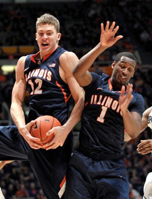 Illinois center Meyers Leonard (12) grabs a rebound from guard D.J. Richardson (1) in the second half of an NCAA college basketball game against Michigan State at Assembly Hall in Champaign, Ill., on Tuesday Jan. 31, 2012. Illinois beat Michigan State 42-41. (AP Photo/John Dixon)