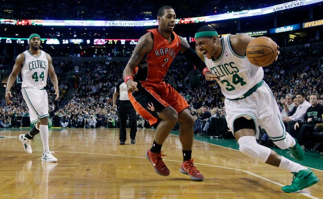 Celtics forward Paul Pierce (34) drives the baseline around Raptors forward James Johnson (2) in the first half.
