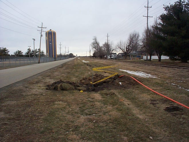 Improving wireless infrastructure
An area where digging cannot be done to install a fiber optic line is marked by yellow caution tape on the east side of North Fourth Avenue in Canton. The orange line at right is the actual 1 1/4-inch fiber optic line to be buried. The line will run from Peoria through Fulton County to Macomb. Numerous colored flags indicate pathways for the line and reflect precautions taken by first contacting Joint Utility Locating Information for Excavators (JULIE, Inc.). The new fiber optic line can handle more traffic than old copper lines, so cell phone and Internet wireless service will be better and faster, according to a spokesman for the project.
