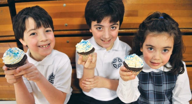 Pictured is Andrew, David, and Elisabeth Gardiner enjoying one of their mom’s cupcakes.
