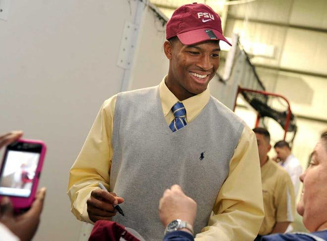 Linda Stelter The Birmingham (Ala.) News Hueytown, Ala., quarterback Jameis Winston smiles for photos after signing a letter of intent to attend and play football at Florida State on Friday.
