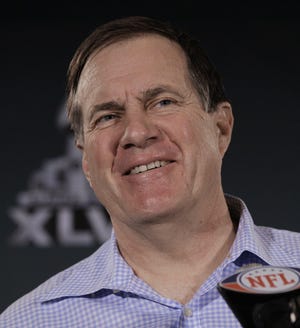 Patriots head coach Bill Belichick answers questions Wednesday during a news conference in Indianapolis. Belichick has shown a lighter side this week leading up to Sunday’s Super Bowl, joking with the press and smiling.