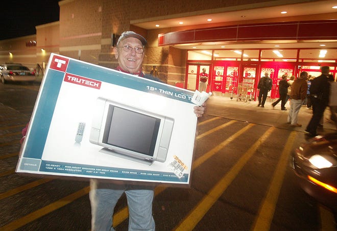 Paul Favino of Warwick, R.I., smiles after purchasing an LCD TV Nov. 24, 2006 at a Target store in Warwick, R.I.