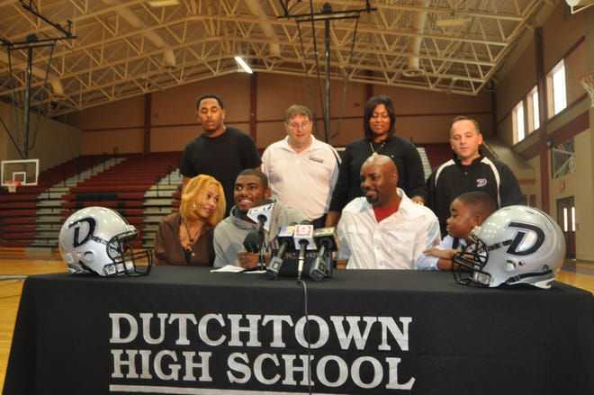 Dutchtown running back Landon Collins signs a letter of intent Wednesday to play football for defending BCS National Champion Alabama. His signing was part of the National Signing Day festivities. He is seated next to his mother April Collins, his father Gerald Collins and half-brother Justin Collins. In the back row are Landon's brother, Gerald Willis, Dutchtown head football coach Benny Saia, stepmother Jamie Collins and