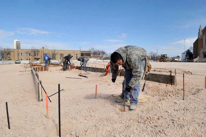 Leonardo Maldonado and other Page and Associates crew members construct curbing forms Monday in the Amarillo College parking lot at Southwest 14th Avenue between South Tyler and South Polk streets.