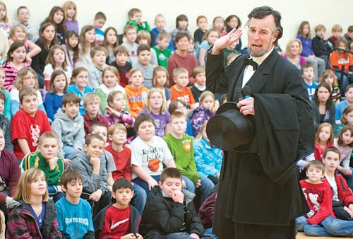 Abraham Lincoln impersonator Fritz Klein tells a story to Washington Central School students during lunch hour Monday. The faux President toured many sites in Washington Monday to promote tourism in the town.