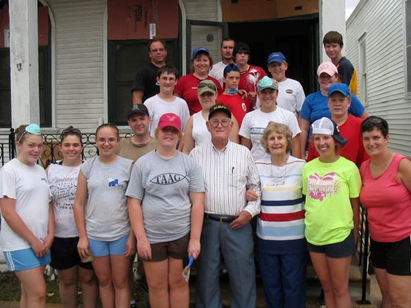 Members of the St. Paul’s Evangelical Lutheran Church youth group and adults who traveled to New Orleans with them in 2007 pose with the World War II veteran and his wife (center front) whose house they repaired. Contributed photo