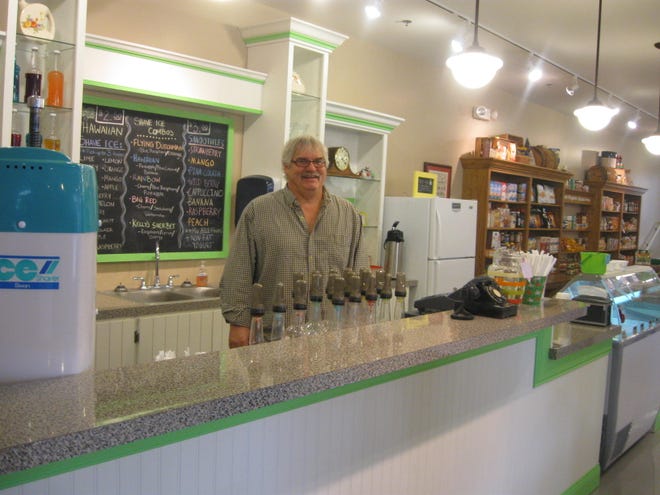 Kelly Owen, owner of Kelly’s Market Place, stands behind the counter, ready to make smoothies.