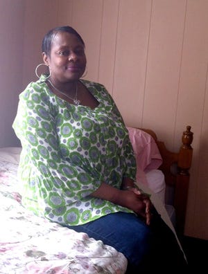 Sandra Smith, a resident of the Katie Blair House operated by Norwich nonprofit Bethsaida Community, sits in a bedroom at the agency’s Cliff Street headquarters. Bethsaida is working to build a transitional housing center in the building.