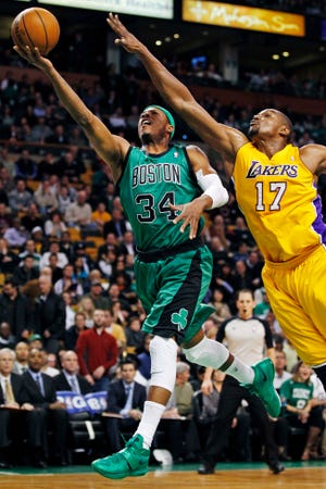 Boston Celtics forward Paul Pierce (34) drives to the basket past Los Angeles Lakers center Andrew Bynum (17) during the first quarter of an NBA basketball game in Boston, Thursday Feb. 9, 2012. (AP Photo/Charles Krupa)
