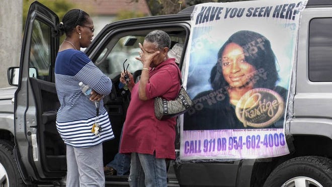 Janet Gauntlett (l) and Lola Sinclair (r), concerned friends of Sharon and Michael Leiba, gather at Pembroke Rd. and 52 Ave. to pass out fliers for the Leiba's missing daughter, Naketa, 17, who has been missing since Feb. 1. when she did not return home after getting off her school bus in Miramar.