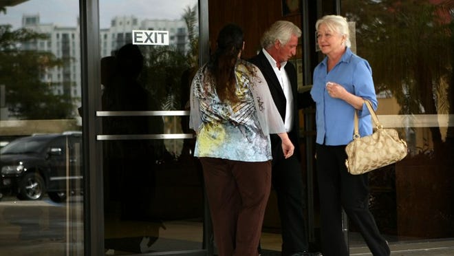From center, John George and Denice Haggerty leave the U.S. District Court in West Palm Beach on Jan. 13, 2012.