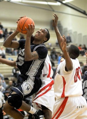 Pocono Mountain West’s Tyrel Dixon, left, shoots against Pocono Mountain East in Swiftwater on Friday.